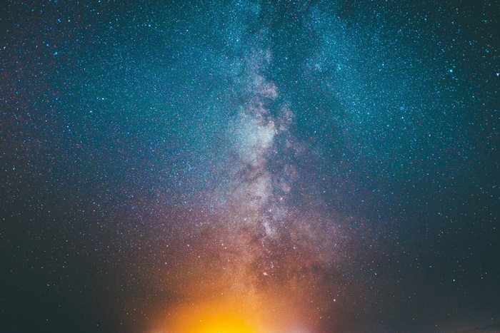 Milky Way galaxy with stars and orange glow