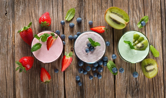 Smoothies with Strawberries, Blueberries, and Kiwi on Wood
