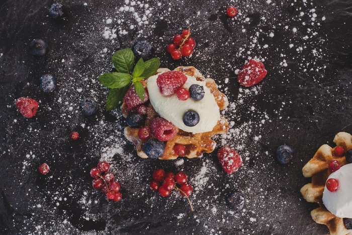 Dessert with berries and cream