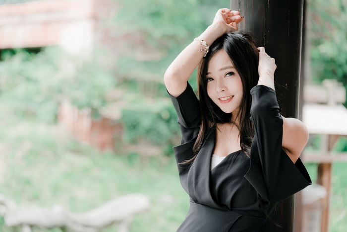 Asian woman in black dress outdoors
