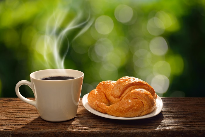 Coffee and Croissant on Wooden Table