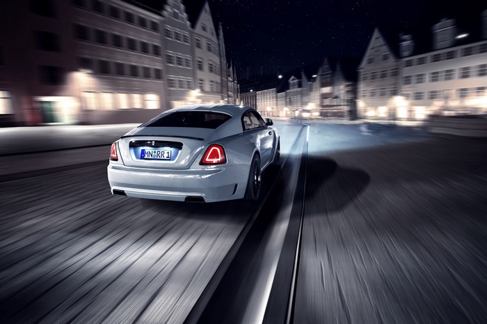 Rolls-Royce Wraith driving through city at night