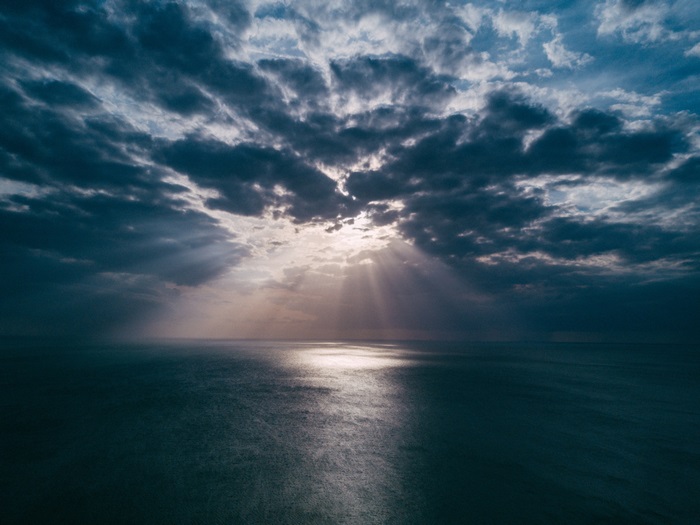 Sunbeams through clouds over the ocean