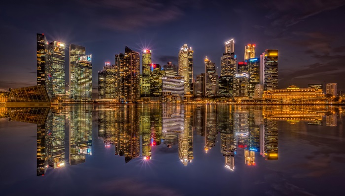 Singapore skyline at night with reflections
