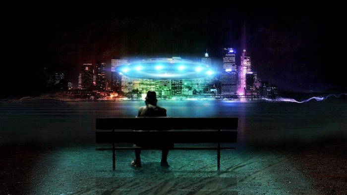 Person on bench watching UFO over city skyline