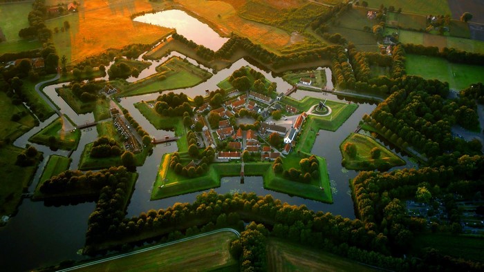 Aerial view of a star-shaped fortress village in the Netherlands at sunset