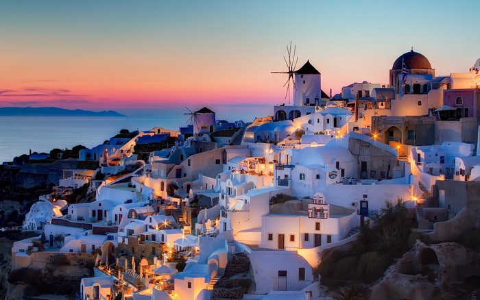 Santorini, Greece at sunset with windmills