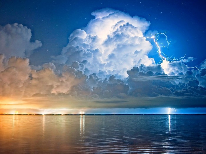 Lightning storm over the sea at night