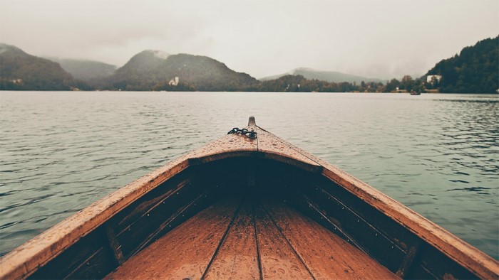 Boat on a lake with mountains in the background