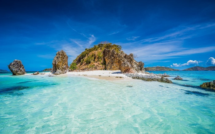 Tropical island with rocky outcrops and clear turquoise water