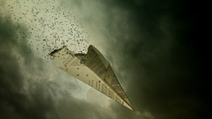 Paper airplane disintegrating into text against stormy sky