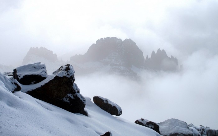 Snow-Covered Rocky Mountain Landscape in Mist