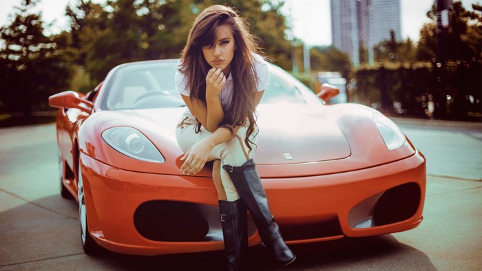 Woman posing on a red Ferrari F430