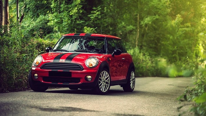 Red Mini Cooper with Black Stripes on a Forest Road