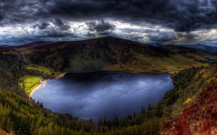 Dark Clouds Over a Lake and Mountains in Ireland