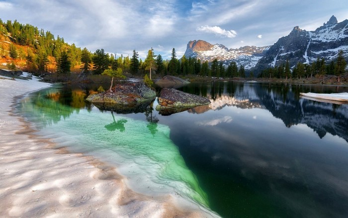 Snowy Siberian Mountain Lake with Forest Reflection