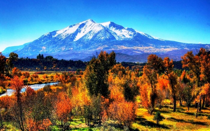 Snowy Mountain Peak Over Autumn Trees and River