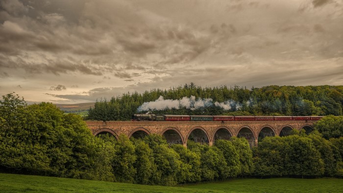 Steam Locomotive Crossing Historic Viaduct in England