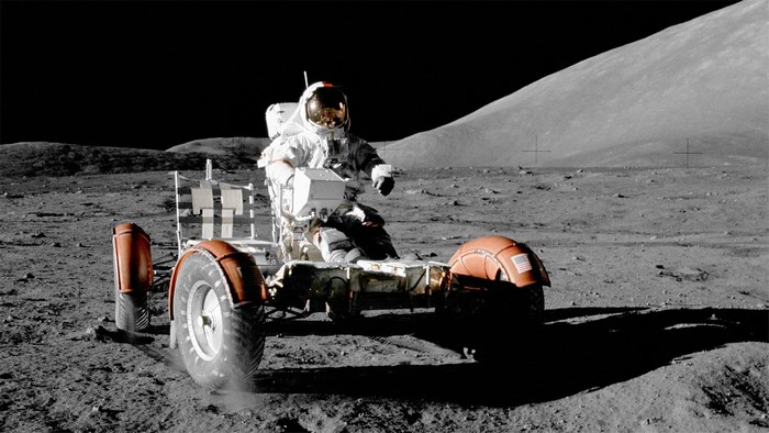 Astronaut driving a lunar rover on the moon