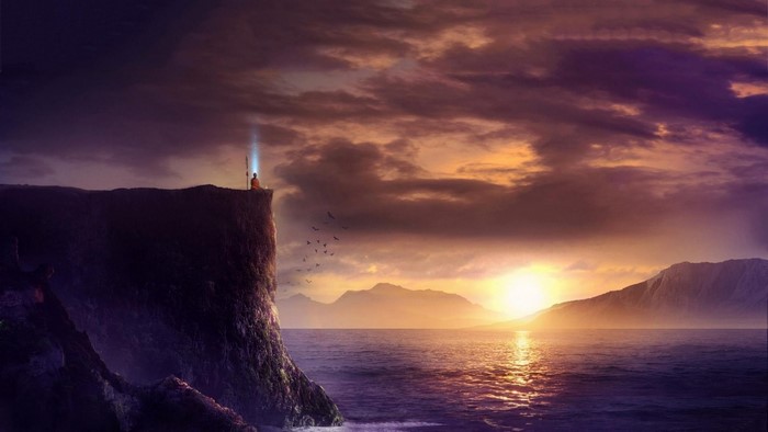 Monk meditating on a cliff at sunset