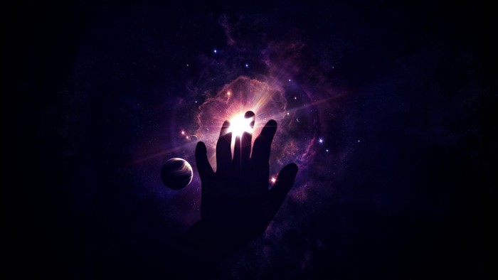 Silhouette of a hand reaching towards a nebula