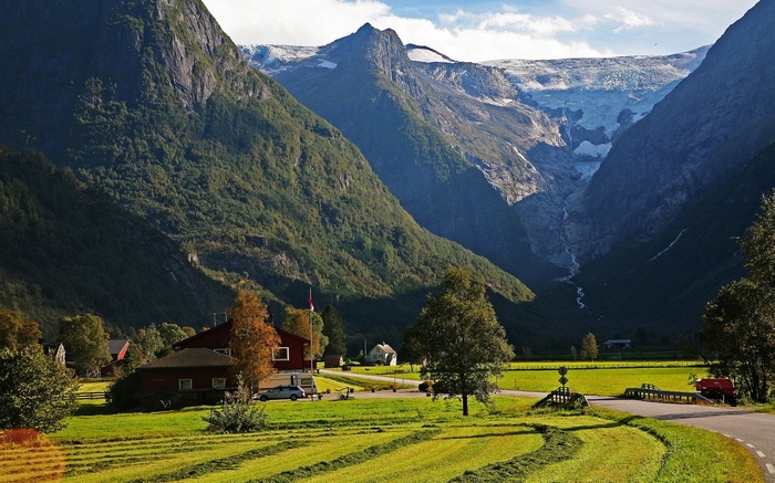 Mountain valley with glacier and village