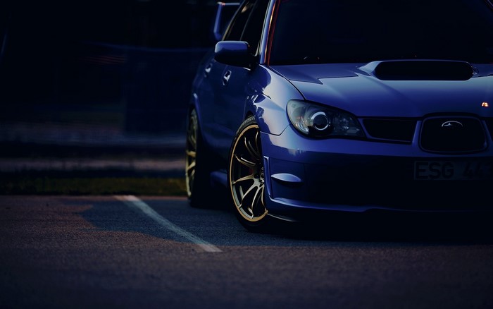 Blue Subaru Impreza WRX STI parked at night