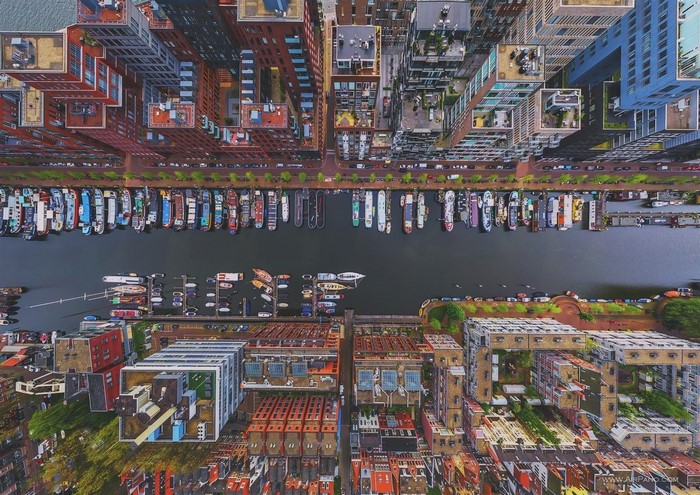 Aerial view of Amsterdam canal with boats and modern buildings