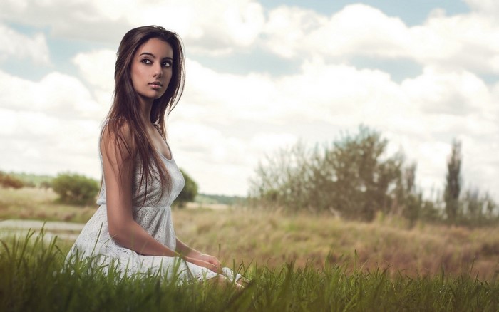 Woman with long hair in a white dress outdoors