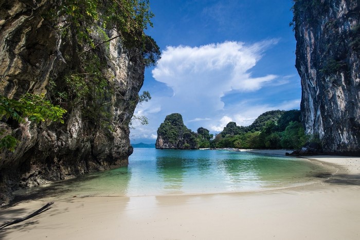Tropical White Sand Beach with Limestone Cliffs in Thailand