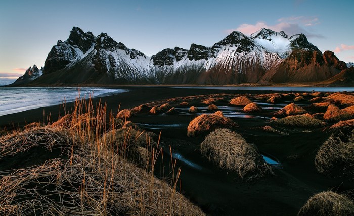 Snow-capped mountains and black sand beach in Iceland