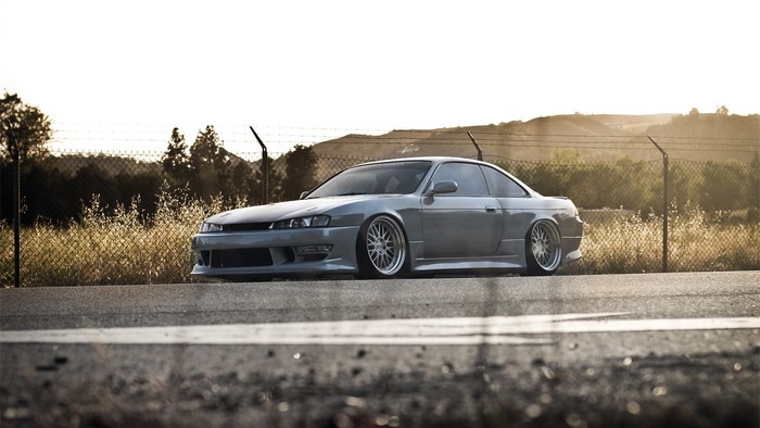 Nissan Silvia S14 parked by a fence