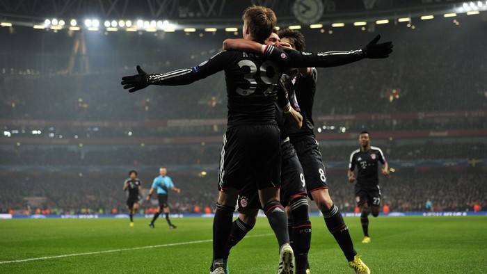 Bayern Munich players celebrating a goal in a stadium