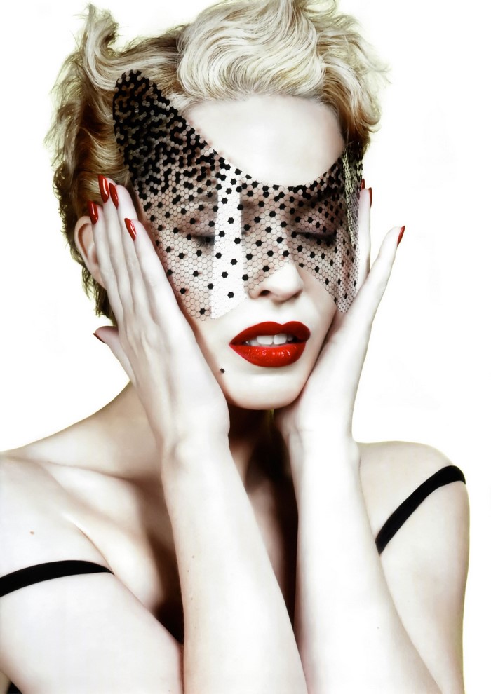 Kylie Minogue wearing a black polka dot mask