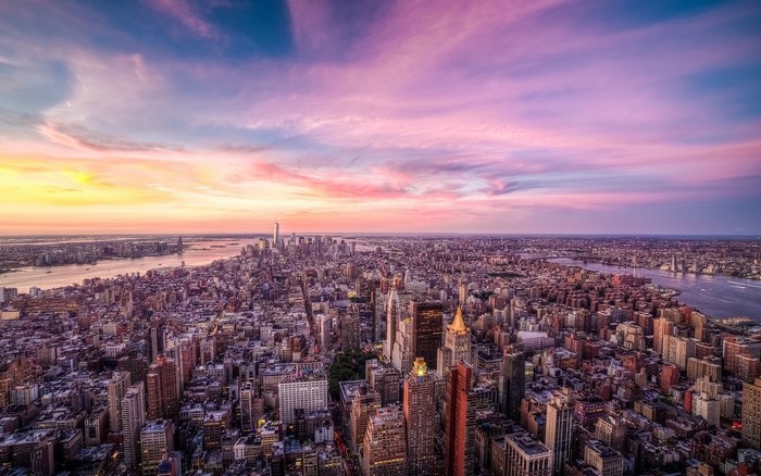 New York City skyline at sunset with colorful clouds