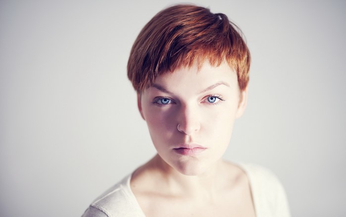Woman with short red hair and blue eyes