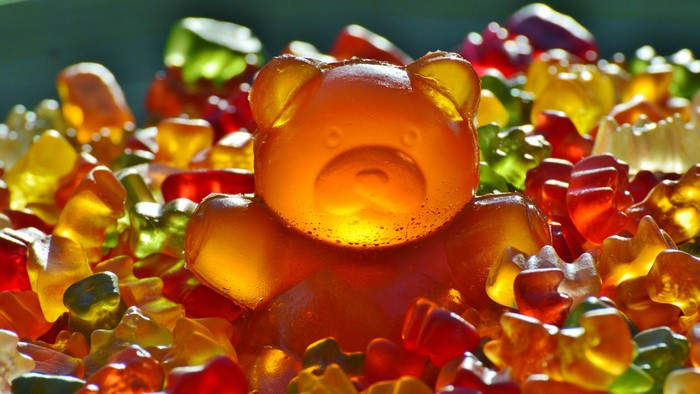 Close-up of colorful gummy bears and a large gummy bear