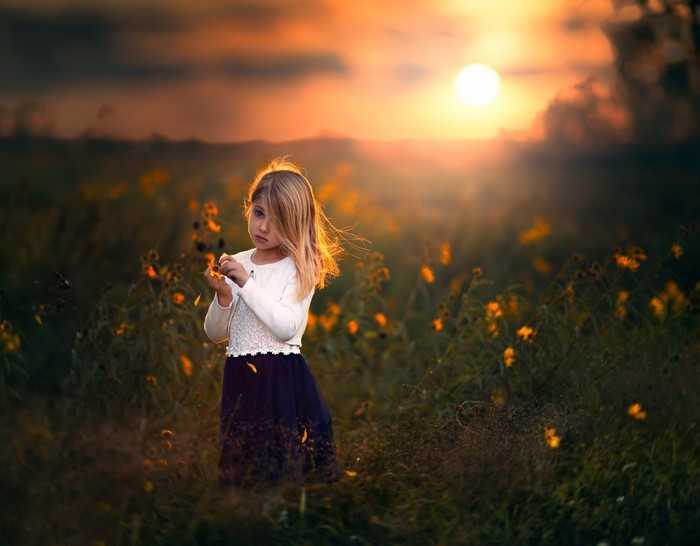 Girl in a field at sunset