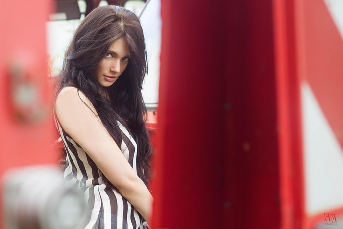 Woman with long dark hair in striped clothing
