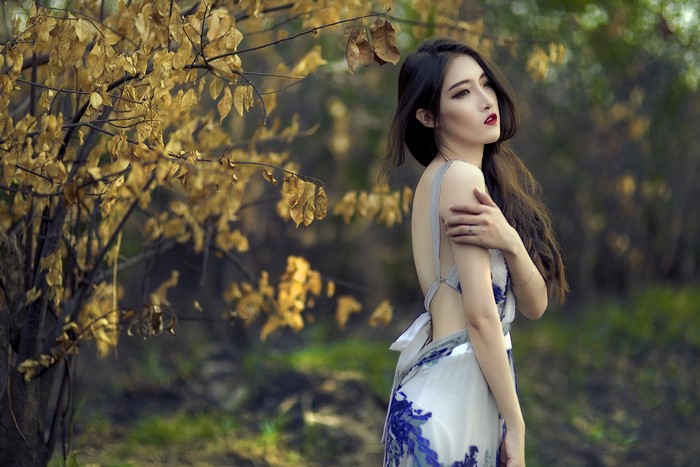 Asian woman in a dress outdoors