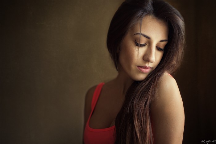 Woman with long brown hair wearing a tank top