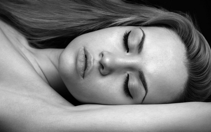 Monochrome portrait of a woman with closed eyes