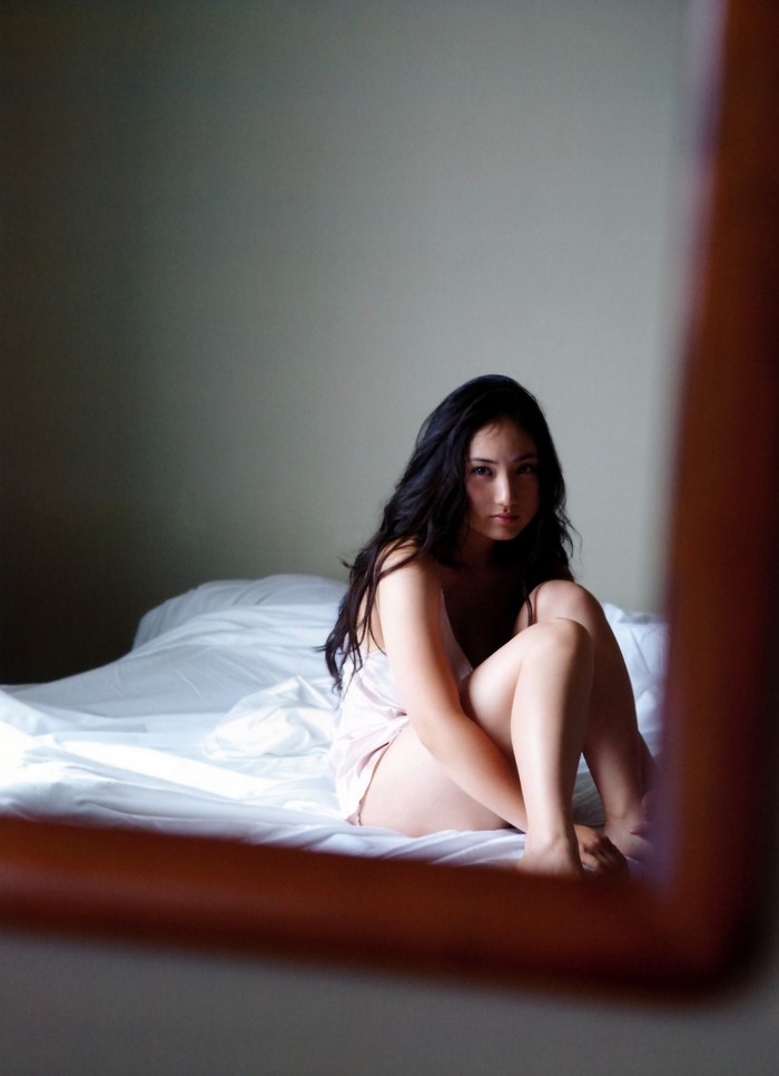 Saaya Irie sitting on a bed