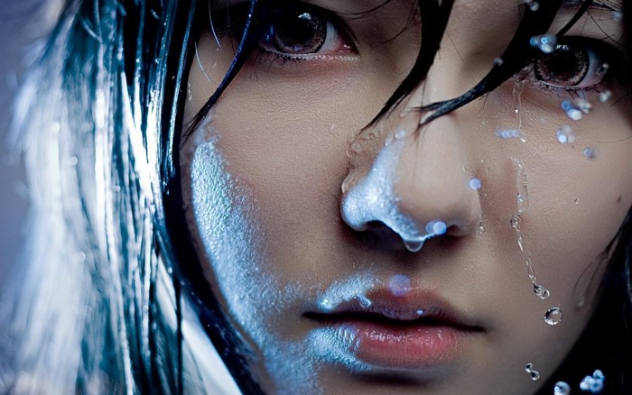 Woman with wet hair and water drops on face