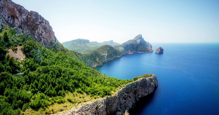 Mountain Peak and Forest Overlooking Rocky Sea View
