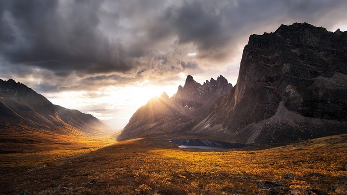 Mountains and valley during sunset with sun rays