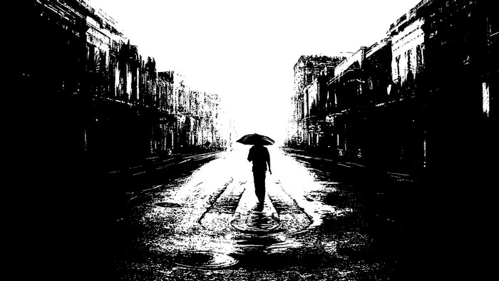 Person with umbrella walking down a wet street