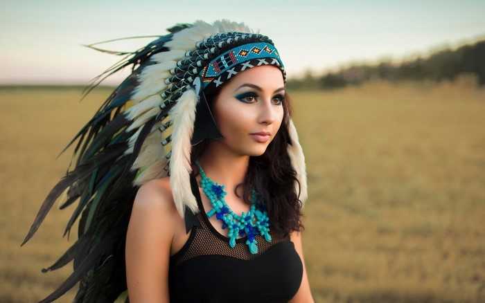 Woman wearing a Native American headdress and necklace
