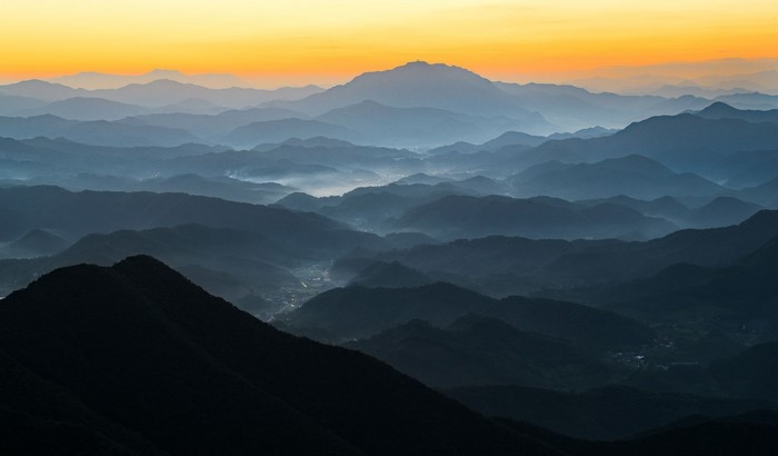 Mountain range with morning mist and sunlight