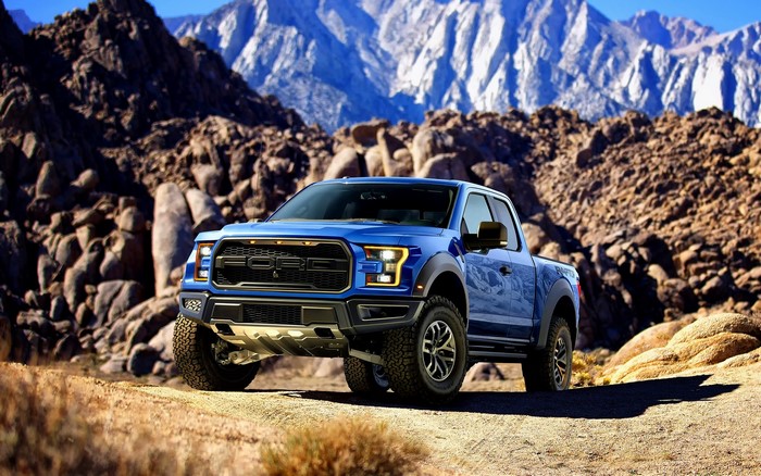 Blue Ford Raptor Truck in Mountains
